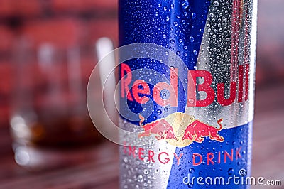 A can, tin of fresh red bull energy drink with brick wall backround. Red bull company is the most popular energy brand in the wor Editorial Stock Photo