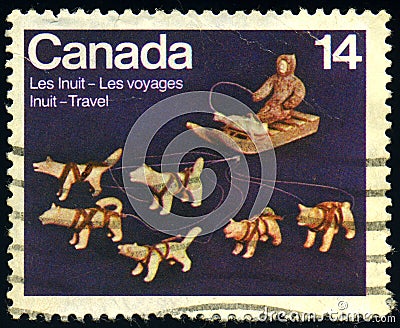 CANADA - CIRCA 1978: stamp 14 Canadian cents printed by Canada, shows Dogteam and Dogsled ivory sculpture by Abraham Kingmeatook Editorial Stock Photo