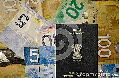 Canadian currency of denomination 5, 10, 20, 100 with Indian Passport Stock Photo