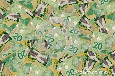 20 Canadian dollars bills lies in big pile. Rich life conceptual background Editorial Stock Photo