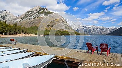 Canadian rocky mountains by Lake Minnewanka reservoir view from boating dock Stock Photo