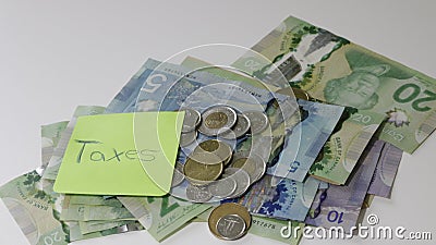 Canadian tax refund spelled with letter tiles and Canadian Dollar notes Editorial Stock Photo