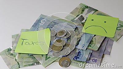 Canadian tax refund spelled with letter tiles and Canadian Dollar notes Editorial Stock Photo