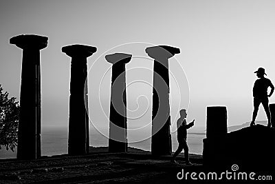 Temple of Athena in Assos with silhouette of woman and man. Black and white photograph Editorial Stock Photo