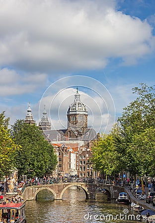 Canal bridge and the St. Nicolas church in Amsterdam Editorial Stock Photo