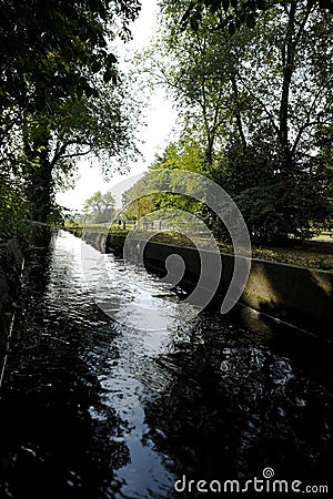 Canal in a park with fluent water Stock Photo