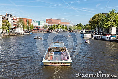 Canal with recreating people in a cruise ship in Amsterdam Editorial Stock Photo