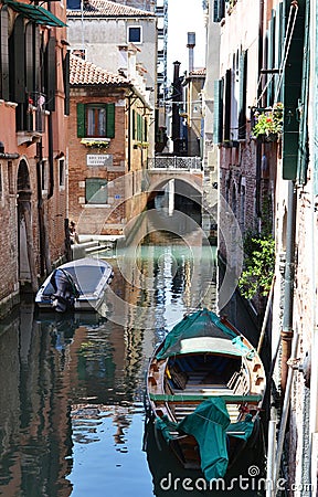 Canal streets of Venice with motorboats anchored at walls of old houses. Editorial Stock Photo