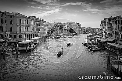 Venice canal and gondola and boats from the Rialto Bridge in black and white Stock Photo