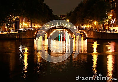 Canals of Amsterdam by night Stock Photo