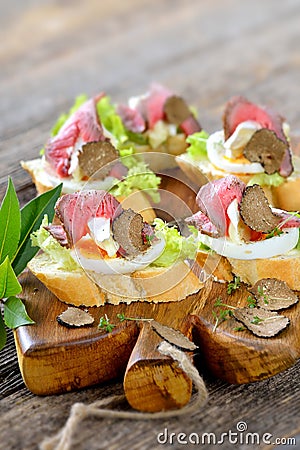 Canapes with roast beef and truffles Stock Photo