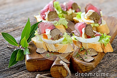Canapes with roast beef and truffles Stock Photo