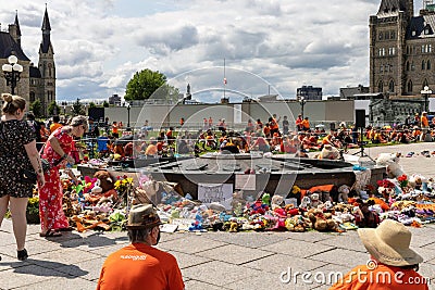 Cancel Canada day protest in Ottawa Canada in 2021 on Parliament Hill in downtown. Shoes and toys left near the Centennial Flame Editorial Stock Photo