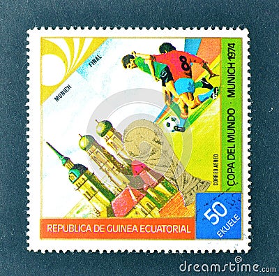 Cancelled postage stamp printed by Guinea Equatorial, that shows Football players, World cup trophy and Munich Editorial Stock Photo