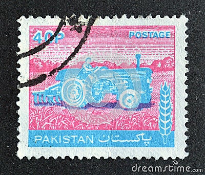 Cancelled postage stamp printed by Pakistan, that shows Woman Tractor Driver Editorial Stock Photo