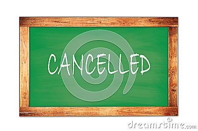 CANCELLED text written on green school board Stock Photo