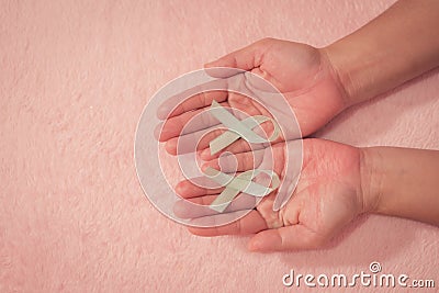 Cancer awareness hand ribbon top view, vintage picture style donate healthcare concept Stock Photo