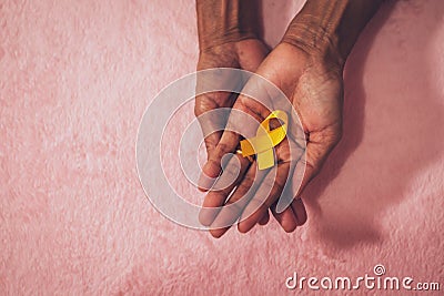 Cancer awareness hand ribbon top view, vintage picture style donate healthcare concept Stock Photo