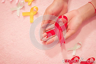 Cancer awareness hand ribbon top view, vintage picture style donate healthcare concept Stock Photo