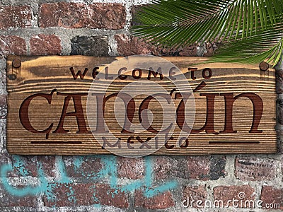 Cancun Mexico Welcome sign engraved in wood on a brick wall tropical Stock Photo