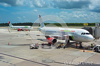 cancun, quintana roo, 20 08 23, Two Mexican airline planes parked at the airport during a cloudy day and people carrying luggage Editorial Stock Photo