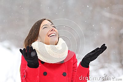Candid happy girl enjoying snow in winter Stock Photo