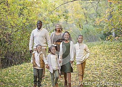 Candid Mixed Race family portrait outdoors with autumn colors Stock Photo