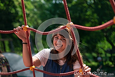 Candid people adorable cheerful girl portrait photography in park outdoor summer time day space with foreground frame work objects Stock Photo