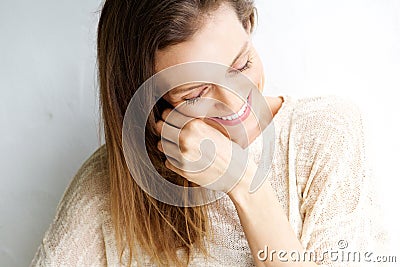 Candid portrait of a woman laughing against white background Stock Photo