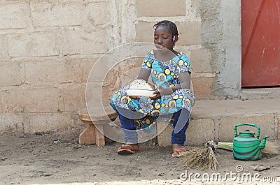 Candid Shot of African Black Girl Cooking Rice Outdoors Stock Photo