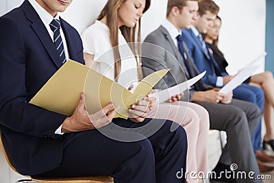 Candidates waiting for job interviews, mid section Stock Photo