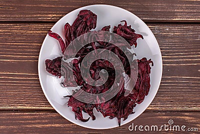 Candied hibiscus on brown wood Stock Photo