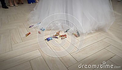 Candies lie on floor next to bride close Editorial Stock Photo