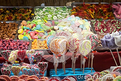 Candies, mainly gummy sweets and lollilpops, diversified, display in loose in a candy shop during a carnival or a fair Stock Photo