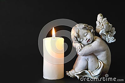 Candle and angel figurine Stock Photo