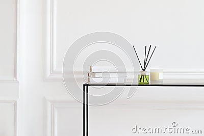 Candle and aromatic reed freshener on table in spa salon. aroma liquid in glass bottle with reed sticks. aroma Diffuser In Luxury Stock Photo