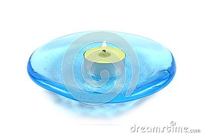 Candle on a blue glass dish Stock Photo