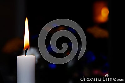 Candle burning in the dark Stock Photo