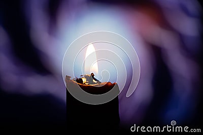 Candle flame on blurred background spark of lightning close-up Stock Photo