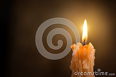 Candle flame close up on a dark background. Melted Wax Candle light border design. Burning at Night, Darkness. Candlelight Stock Photo