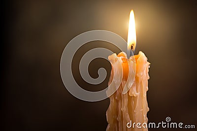 Candle flame close up on a dark background. Melted Wax Candle light border design. Burning at Night, Darkness. Candlelight Stock Photo