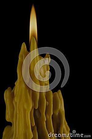 Candle flame melting wax to create dramatic and unique patterns and textures orange Buddhist candles Stock Photo