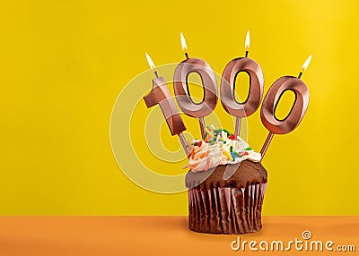 Number 1000 anniversary candle - Celebration on yellow background Stock Photo