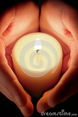 Candle between the hands Stock Photo