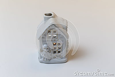 Candle holder in shape of snowy house on white background Stock Photo
