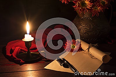 The candle illuminates the Desk Stock Photo