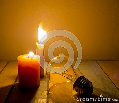 Candle light shine on incandescent bulb Stock Photo