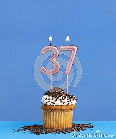 Candle number 37 - Birthday card with cupcake on blue background Stock Photo
