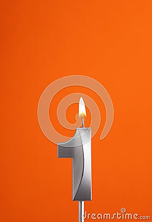 Candle number 1 - Birthday in orange foamy background Stock Photo