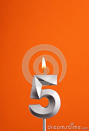 Candle number 5 - Birthday in orange foamy background Stock Photo